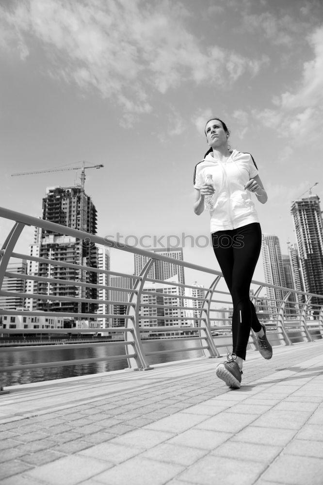 Similar – Image, Stock Photo Young couple running on a seafront promenade