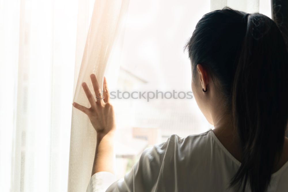 Similar – Dreaming girl looking away in window