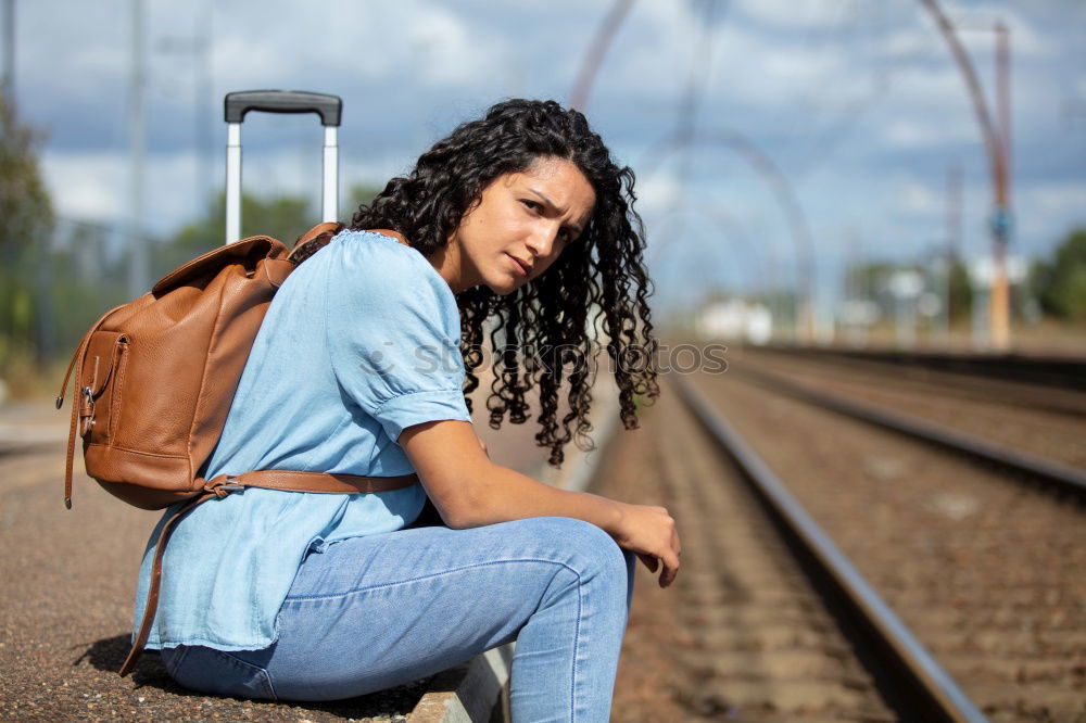 Similar – Sad girl teenager sitting on rusty rail track outside the town. Escape to be alone