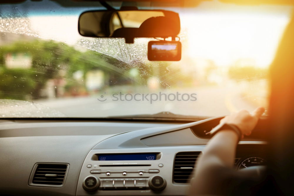 Image, Stock Photo Sunny car ride. View through the windshield onto the highway. Eyes and glasses of the driver as reflection in the rear view mirror.