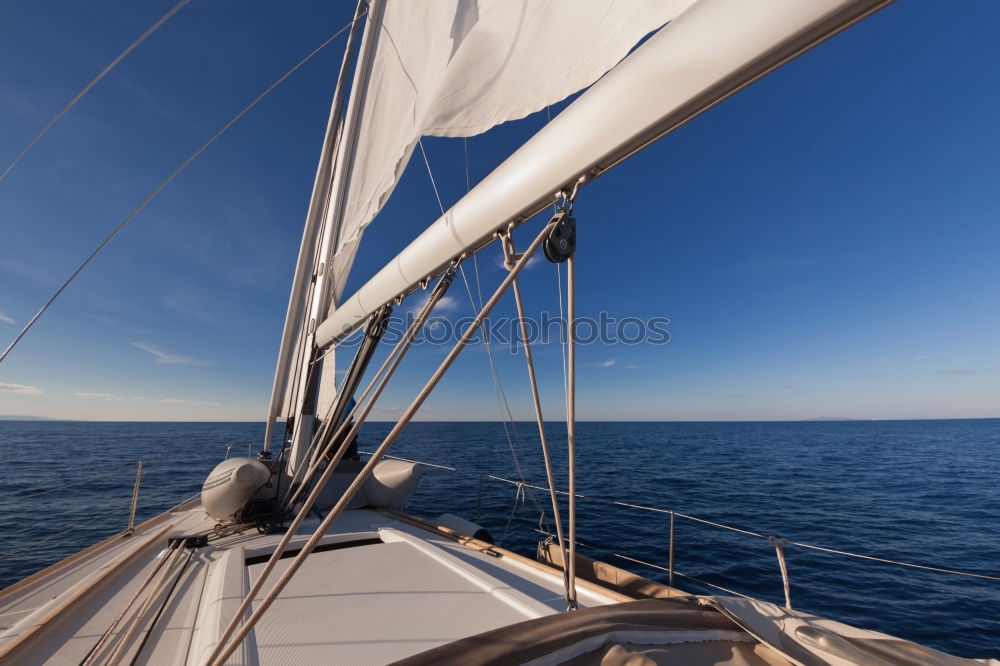 Similar – Sailing in a sailing boat with wooden superstructure with waves hard on the wind the sea foams