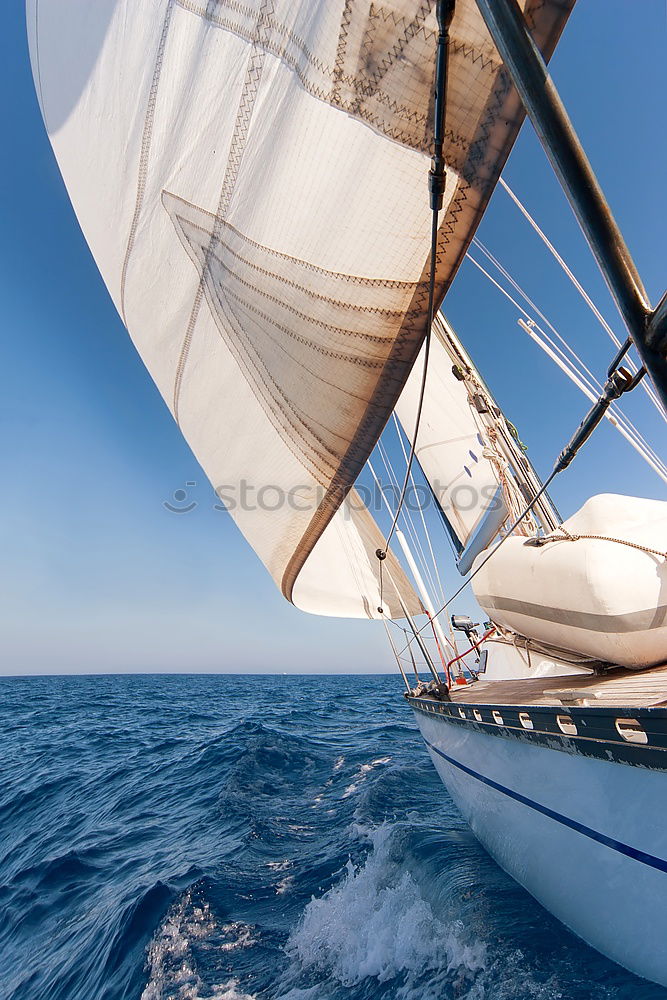 Similar – Sailing in a sailing boat with wooden superstructure with waves hard on the wind the sea foams