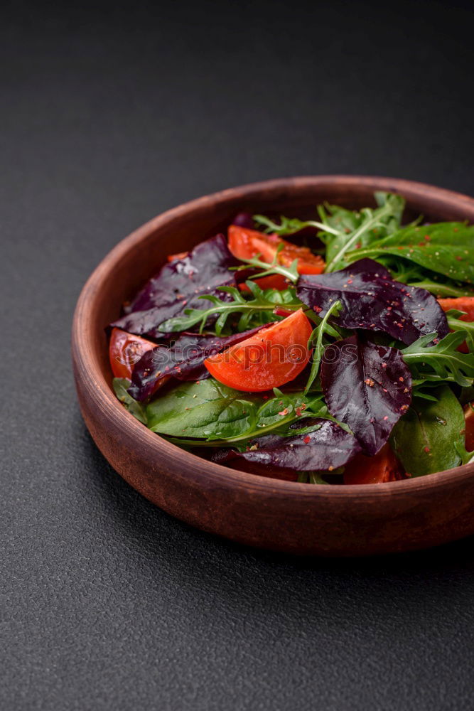 Similar – fresh salad on dark wooden table