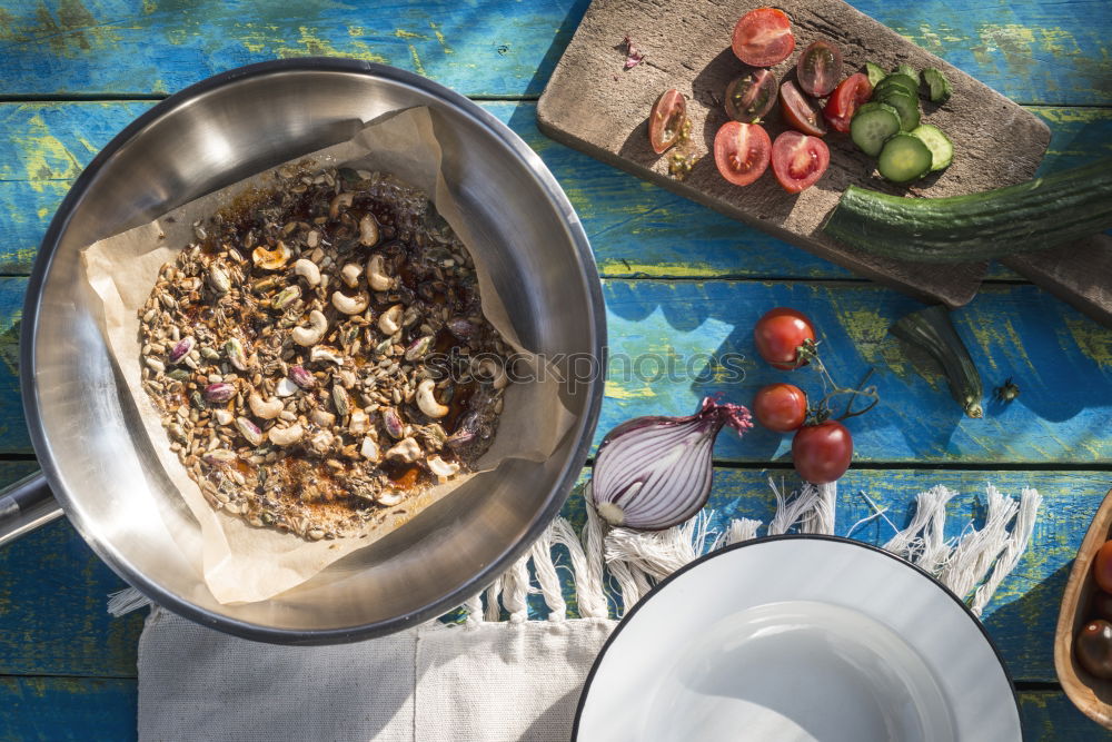 Salad with tomatoes, cucumber, onion and caramelized nuts