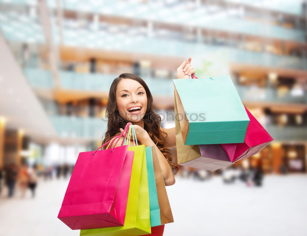 Similar – Shopping bags on womans hand. Woman shopping with colored paper bags.