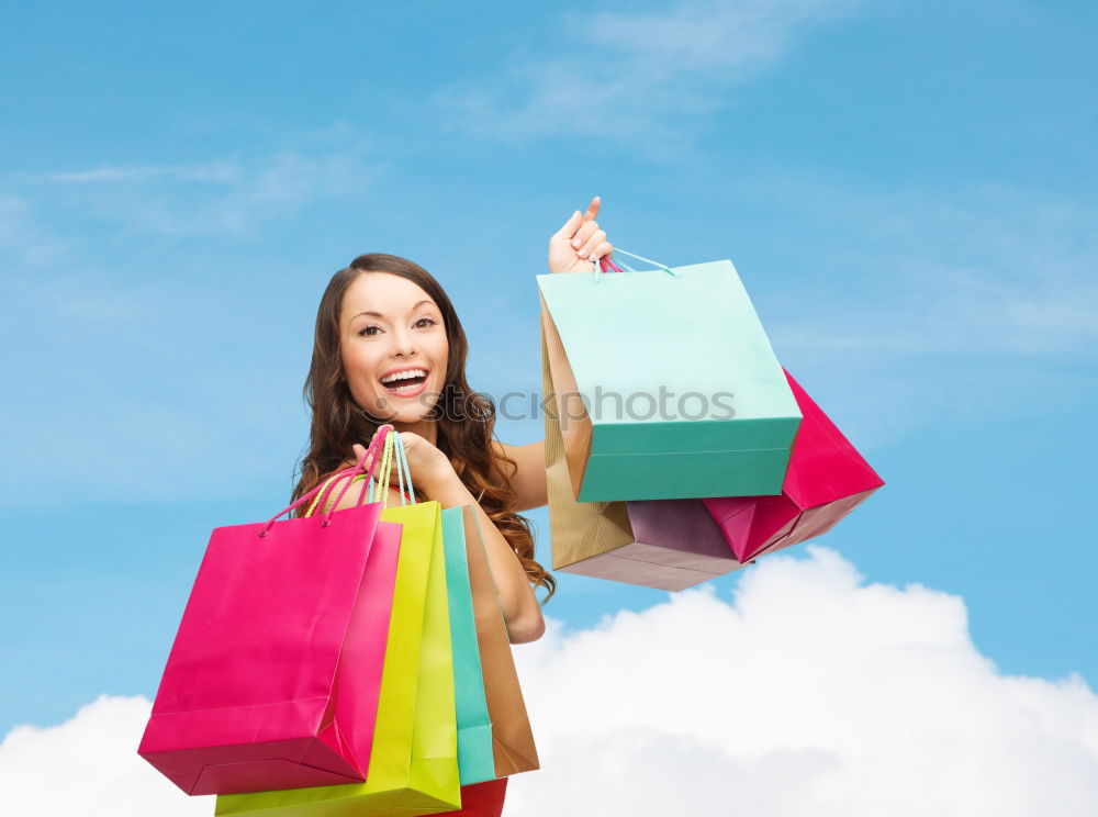 Similar – Shopping bags on womans hand. Woman shopping with colored paper bags.