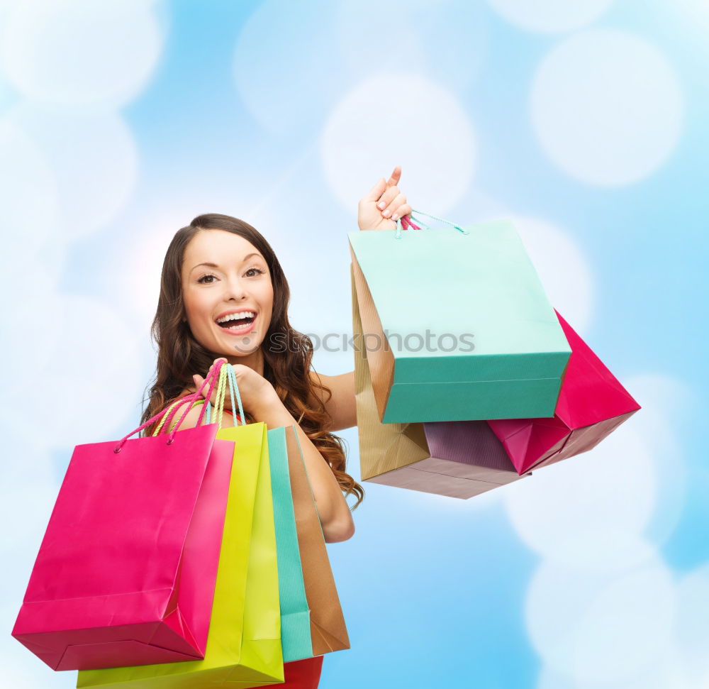 Similar – Shopping bags on womans hand. Woman shopping with colored paper bags.