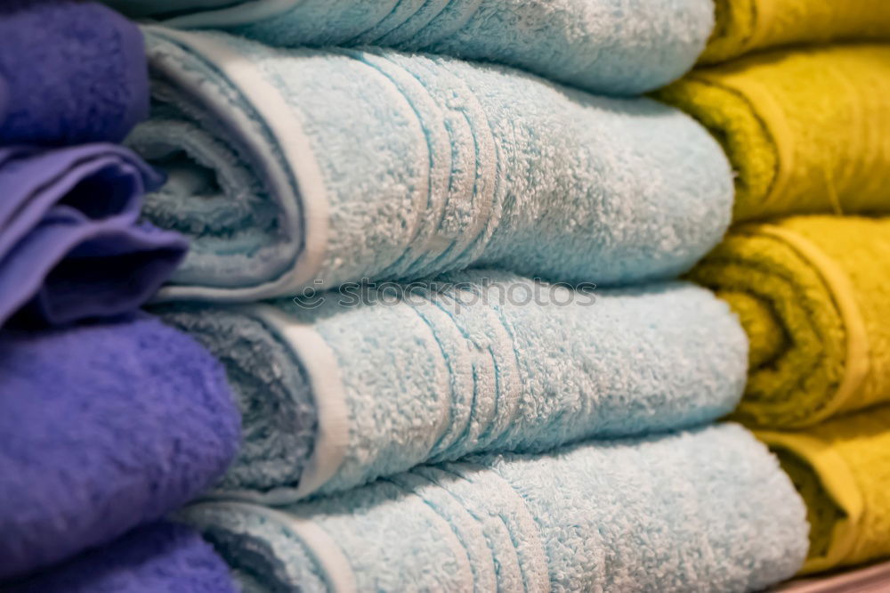 colourful washcloths hang in a row from the heating in the bathroom