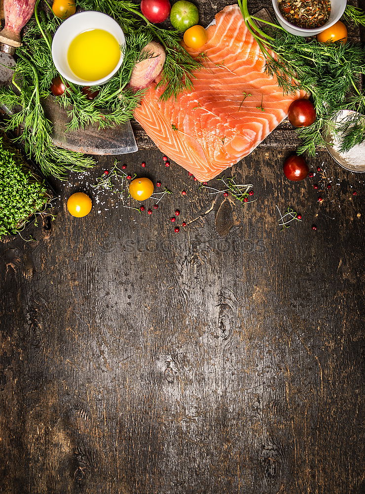 Similar – Salmon fish fillets on chopping board with fresh vegetables