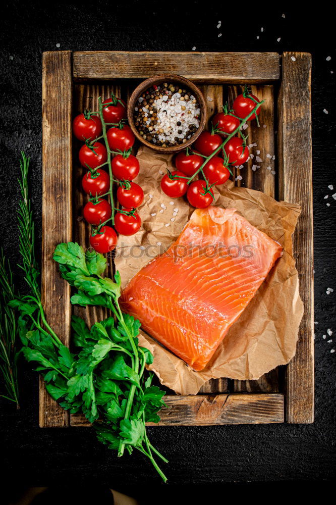 Similar – Salmon fish fillets on chopping board with fresh vegetables