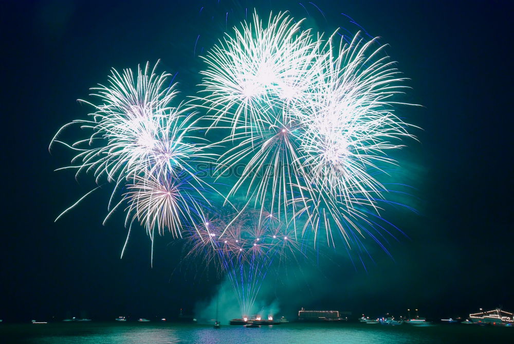 Similar – Colorful fireworks above a lake