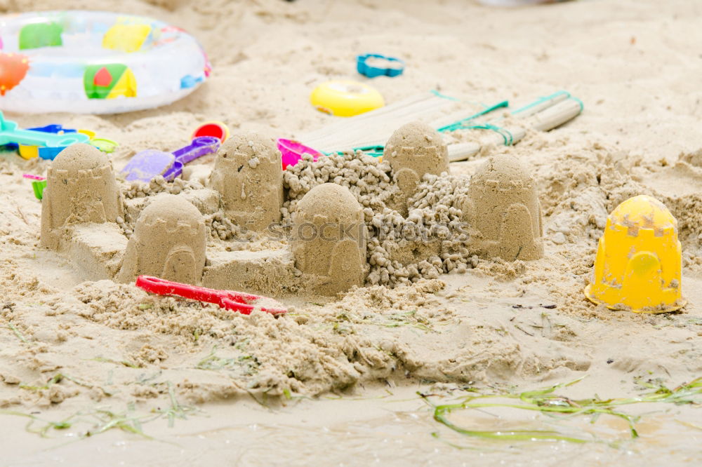 Image, Stock Photo Towel, floats, water gun and sunscreen on the beach