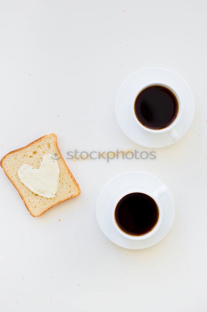 Image, Stock Photo Overhead view of a cup of black espresso coffee and a freshly baked croissant for breakfast. High angle close up