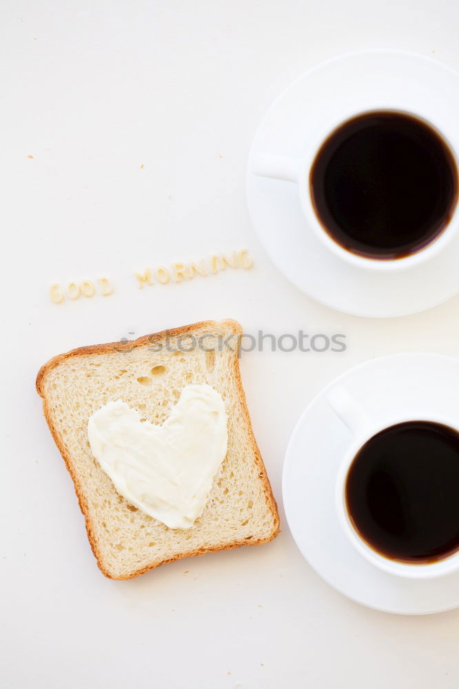 Similar – Image, Stock Photo Overhead view of a cup of black espresso coffee and a freshly baked croissant for breakfast. High angle close up