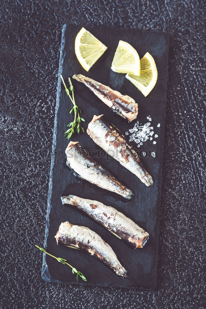 Similar – Image, Stock Photo Grilled sardines on baking tray with ingredients: lemon, garlic and herbs for tasty seafood eating. Cooking preparation of fishes