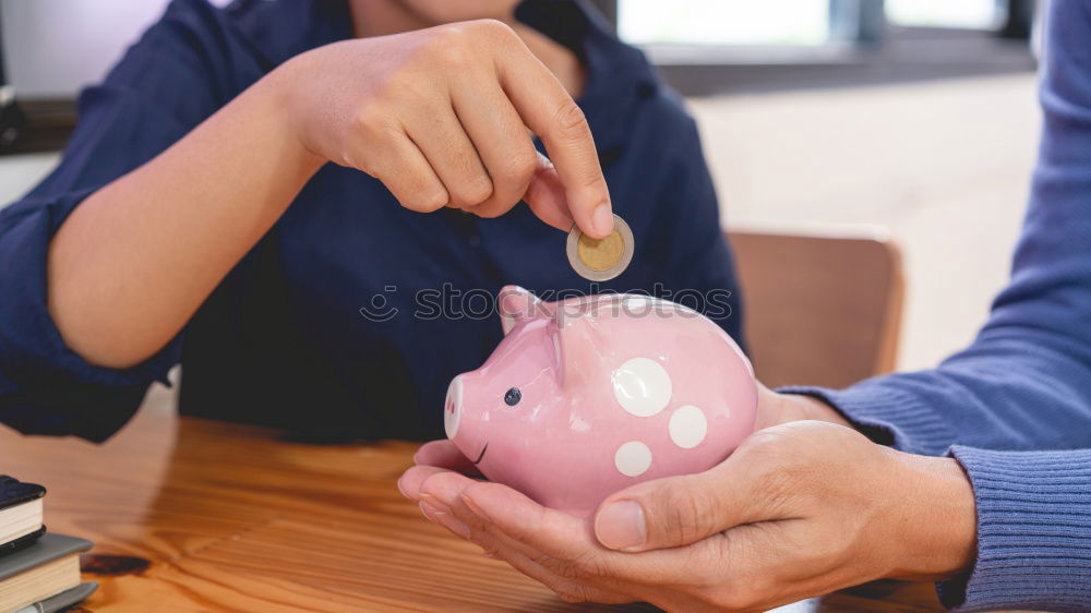 Similar – Thoughtful confused black woman with piggy bank