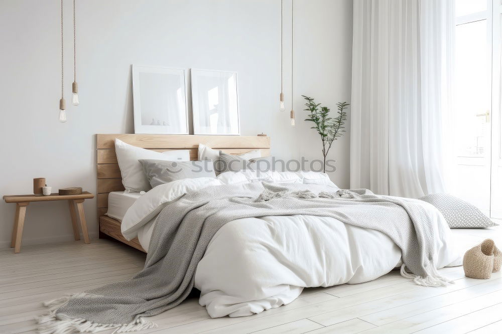 Similar – Ein Doppelbett mit weißer Bettwäsche und beigen Kissen in einem hellen skandinavischen Schlafzimmer, ein Bett auf dem Boden und Blumen in einer Vase