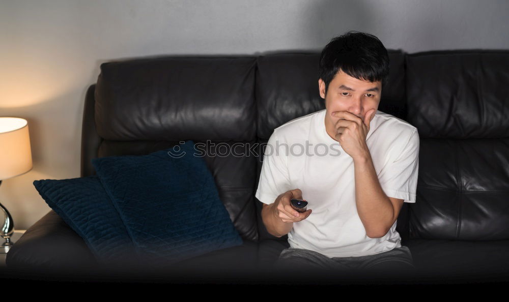 Similar – Relaxed boy holding smartphone sitting in chair at home