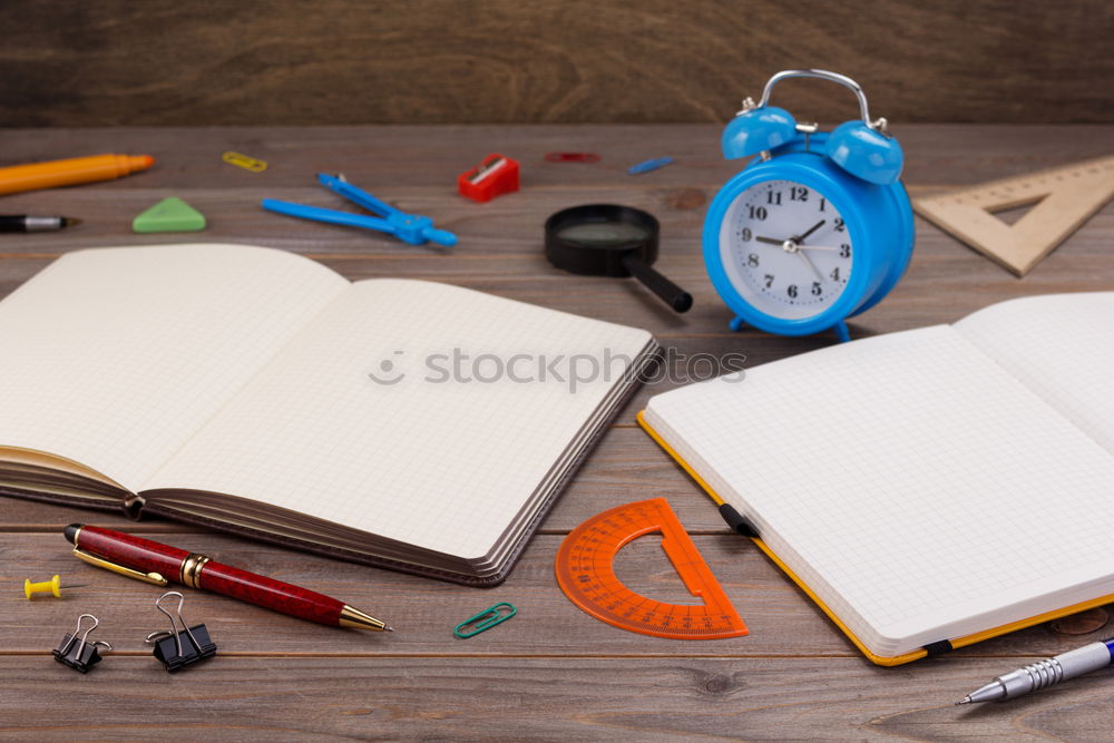 Similar – Red and black desk utensils on a wooden table. notebook, pencils, ruler, tape, sharpener, paper clips, book, stapler