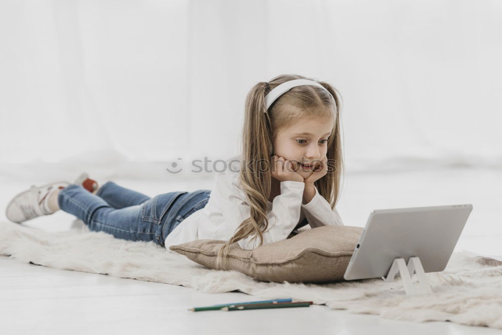 Similar – Little girl using a tablet at home