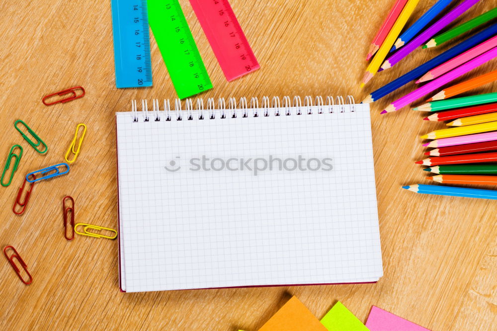 Similar – Notepads, papers, markers and other stationery on wooden table