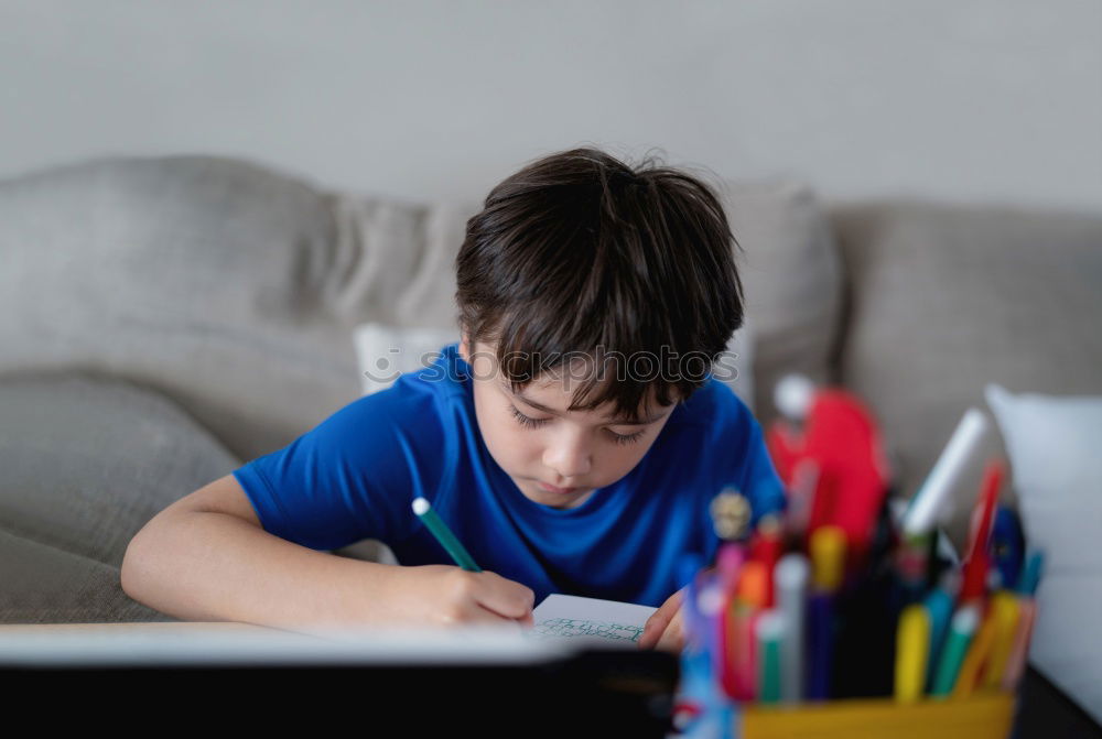 Similar – Image, Stock Photo young boy looking at tablet pc computer with frustrated look on his face