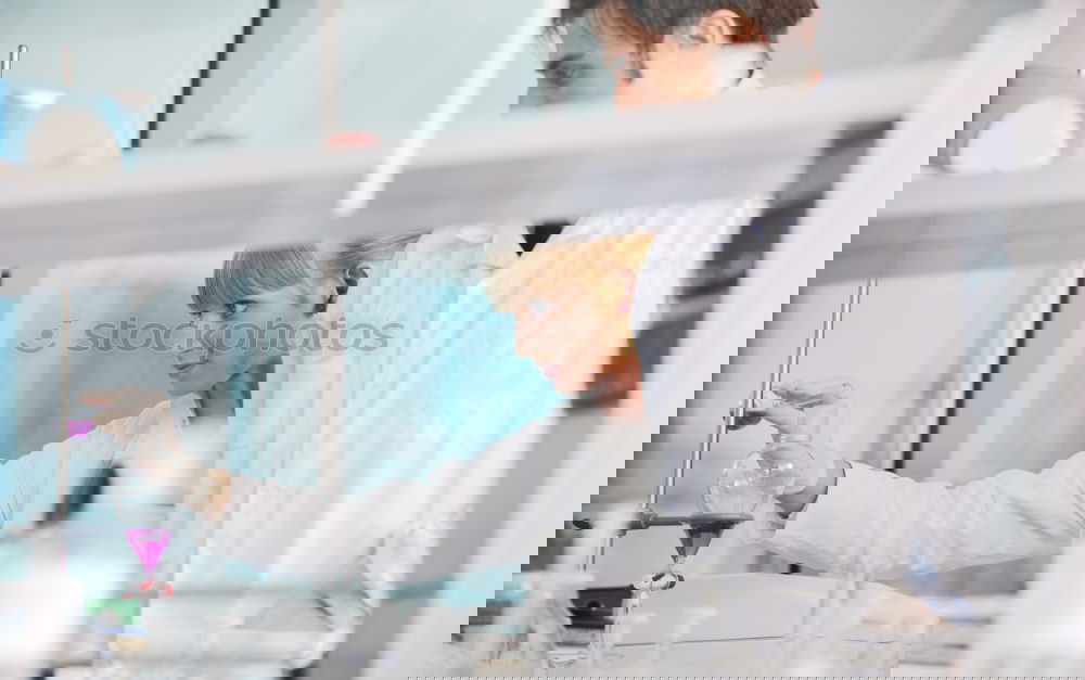 Similar – Image, Stock Photo Woman holding flask in lab