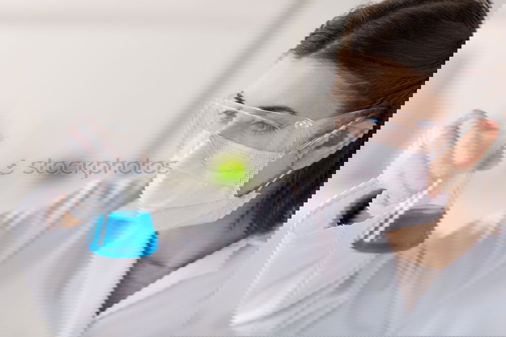 Similar – Image, Stock Photo Woman holding flask in lab