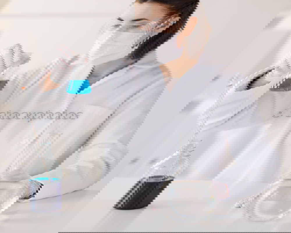 Similar – Image, Stock Photo Woman holding flask in lab