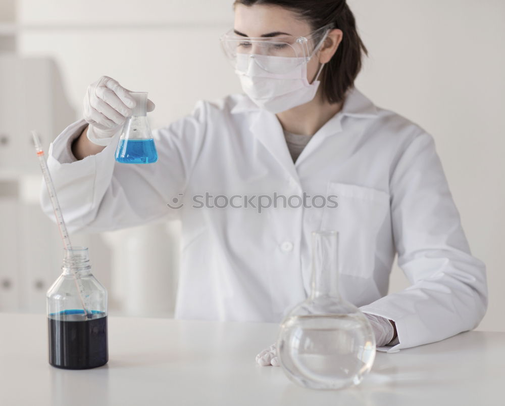 Similar – Worker putting liquid to test tube