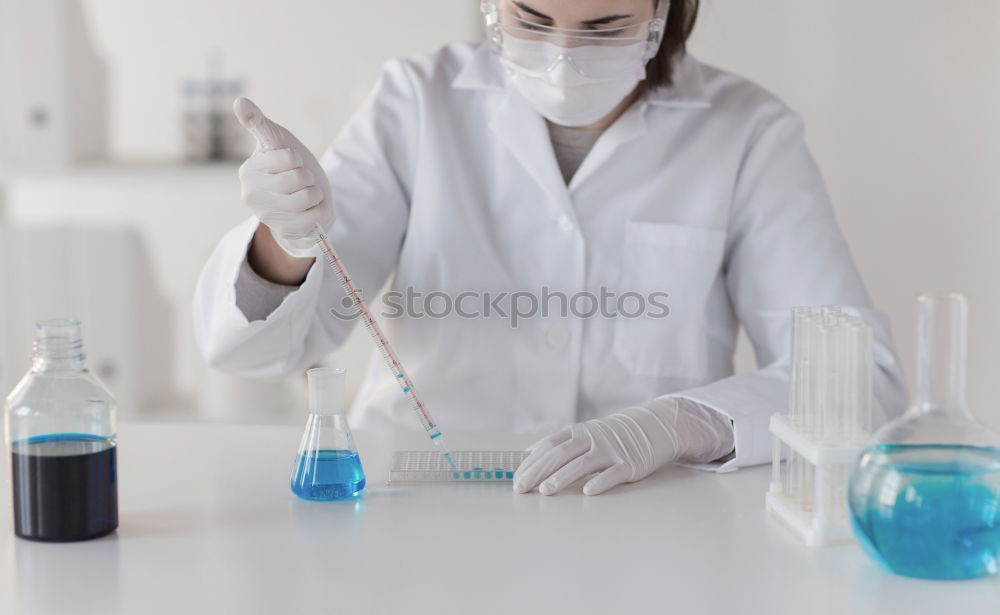 Similar – Worker putting liquid to test tube