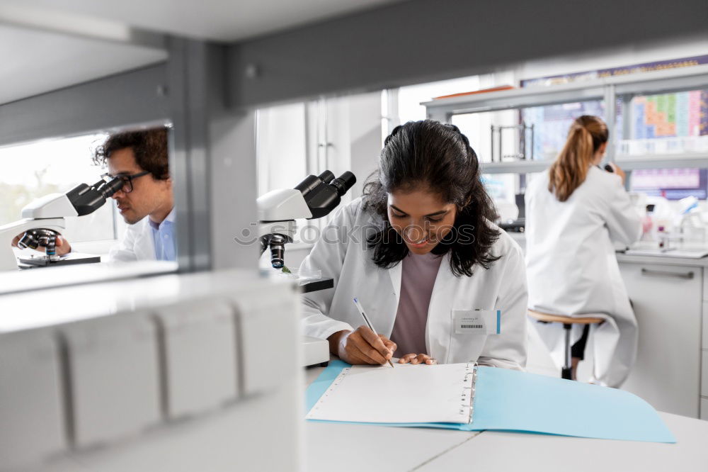 Similar – Image, Stock Photo Workers communicating in lab