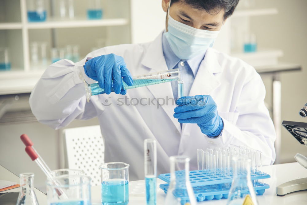 Similar – Worker putting liquid to test tube