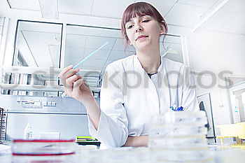 Similar – Image, Stock Photo Woman looking at test tube