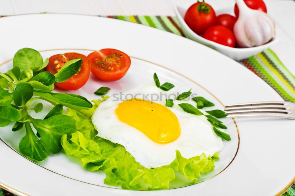 Similar – Fried egg with tomatoes and herbs on a old frying pan