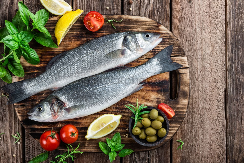 Similar – Image, Stock Photo Two Dorado fish with cooking ingredients