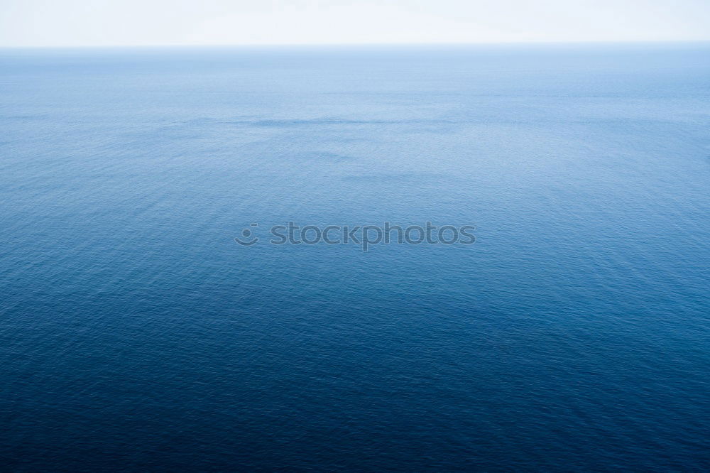 Similar – Blue ocean background with blue sky