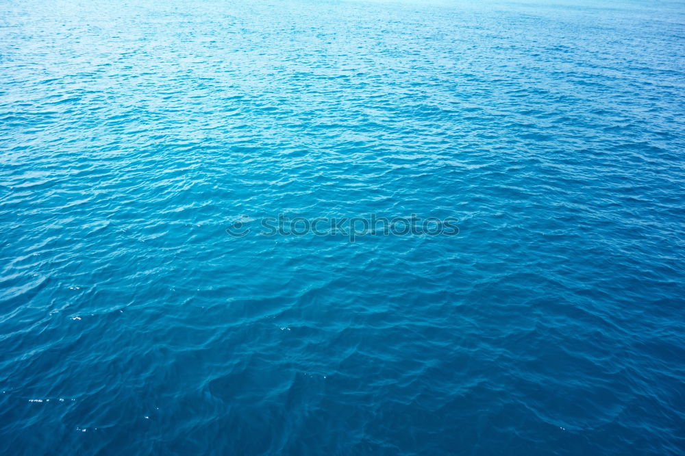 Similar – Blue water with sun line