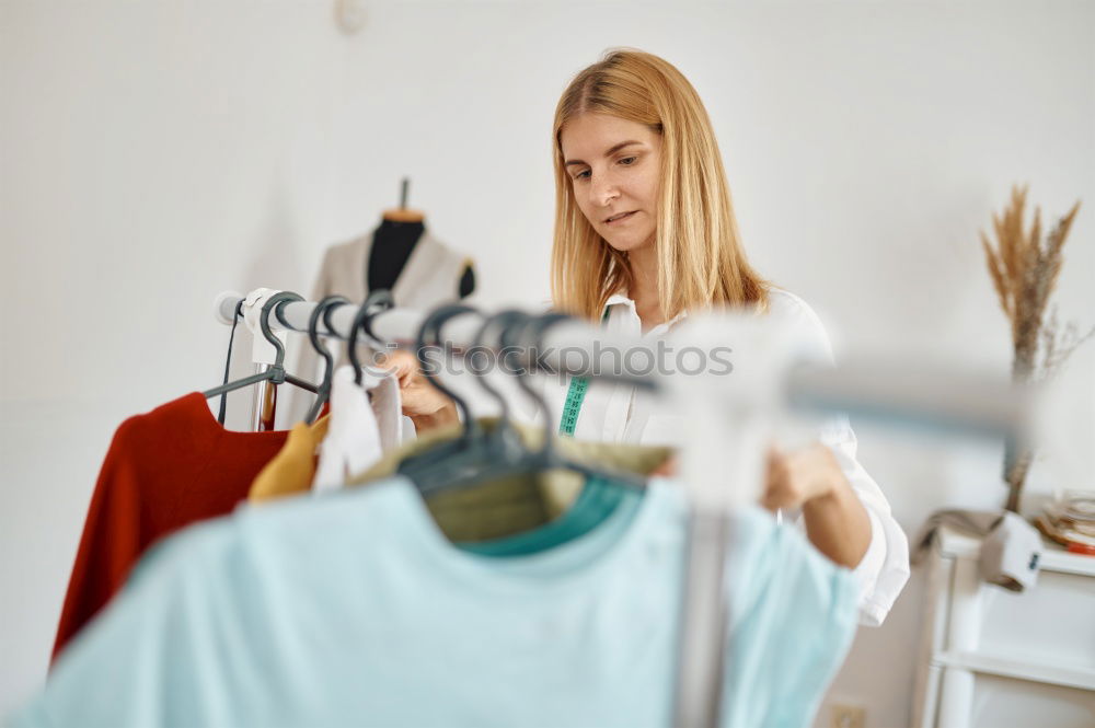 Similar – Image, Stock Photo Two young women going through clothes from their wardrobe at home