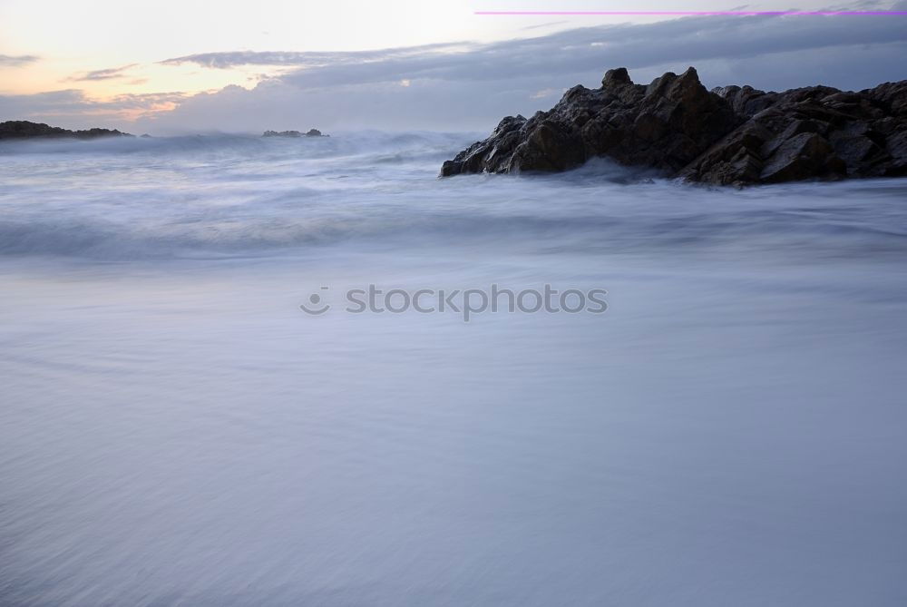 Rocks with spray in sunset in Portugal