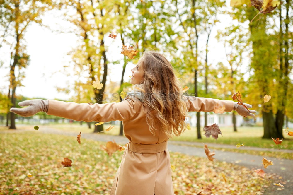 Similar – Image, Stock Photo Joyful young woman throwing autumn leaves