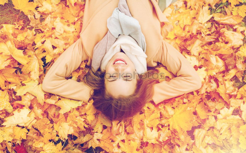 Image, Stock Photo Young woman lying down in the floor full of autumn leaves