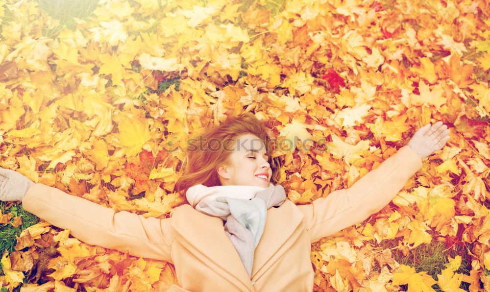 Similar – Image, Stock Photo Young woman lying down in the floor full of autumn leaves