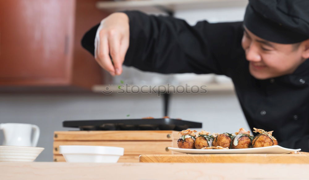 Similar – Female chef cutting japanese sushi roll