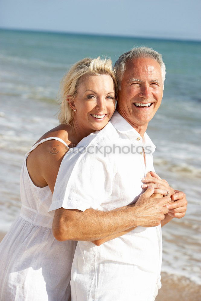 Similar – Senior man and woman having a run along the shore. Scene with sea, sand and trees. Healthy and active way of life