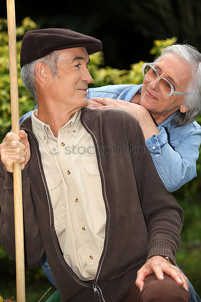 Image, Stock Photo Portrait of two laughing seniors, one with silver-grey curls and glasses, the other with cap in front of an old wall