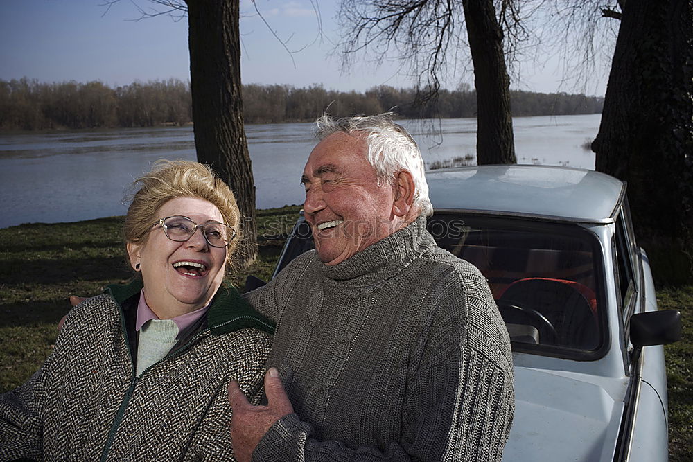 Similar – Image, Stock Photo Portrait of two laughing seniors, one with silver-grey curls and glasses, the other with cap in front of an old wall