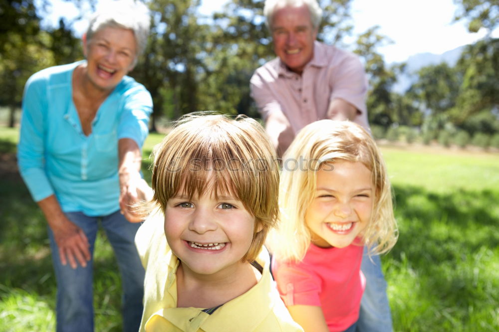 Similar – Image, Stock Photo Baby girl playing with hat of senior man over a nature background