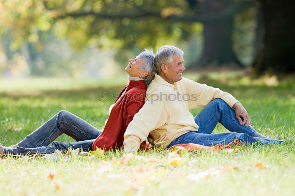 Similar – Image, Stock Photo 2 seniors in love are sitting on a bench in the vineyard and look into the Ahr valley. The man points to something.