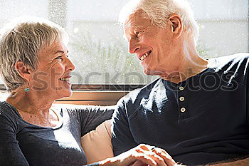 Similar – Smiling senior couple looks lovingly into each other’s eyes